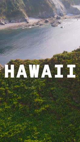 Vertical-Video-Drone-Shot-Of-Island-Coastline-With-Ocean-Overlaid-With-Animated-Graphic-Spelling-Out-Hawaii